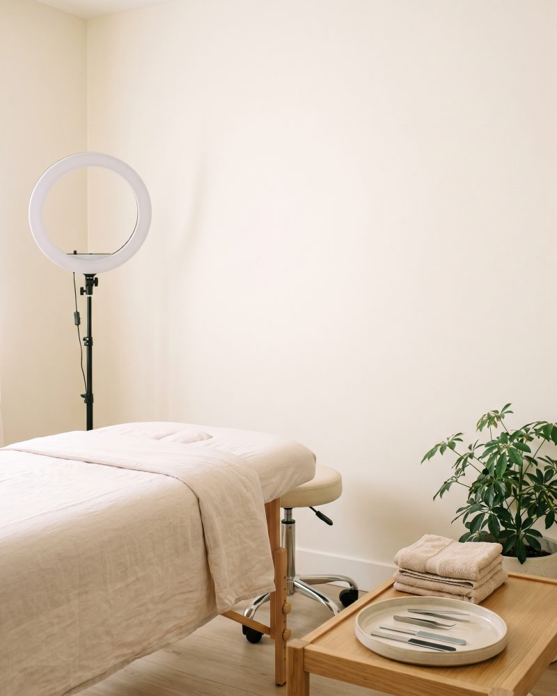 The treatment room at the Vancouver studio, warm daylight on a clean neutral wall.